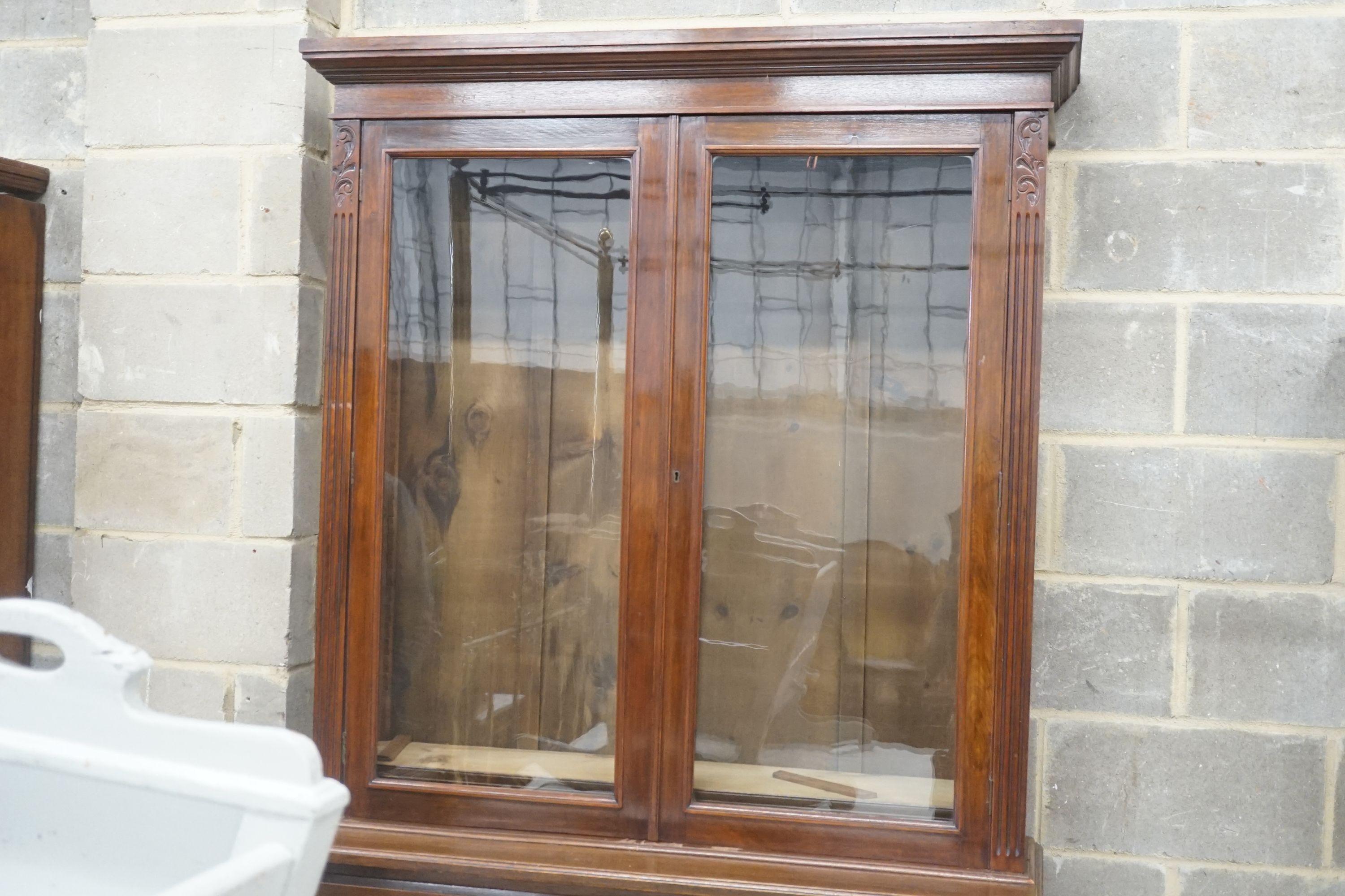 A late Victorian carved walnut bookcase, width 120cm depth 43cm height 220cm